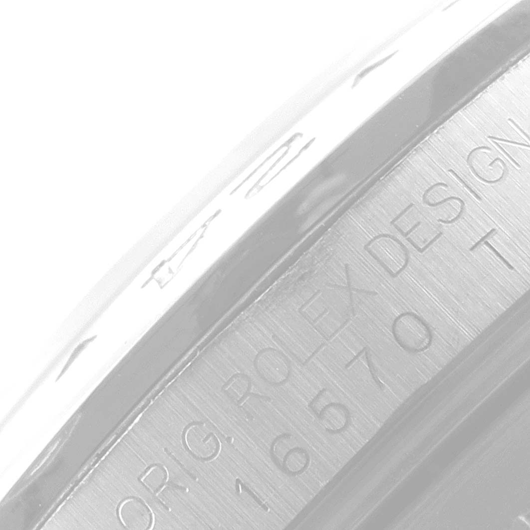 This is a close-up view of the side of a Rolex Explorer 16570 Men
s Stainless Steel Black Dial 16570 Men
s Stainless Steel Black Dial watch, showing design details and part of an inscription.