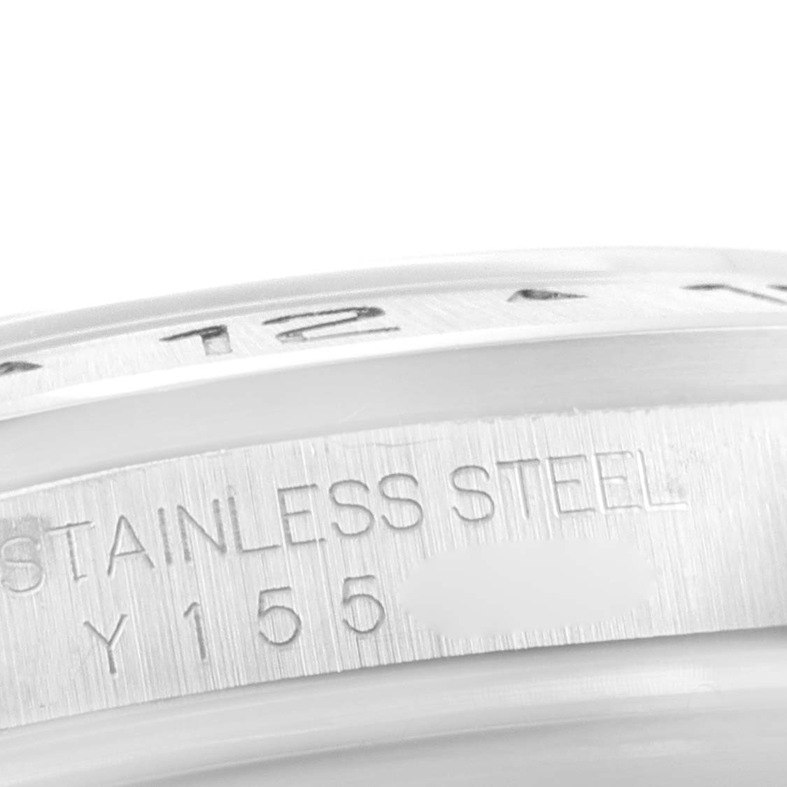 This close-up shows part of the bezel and case edge of the Rolex Explorer 16570 Men's Stainless Steel Black Dial 16570 Men's Stainless Steel Black Dial watch, emphasizing its "STAINLESS STEEL" inscription.