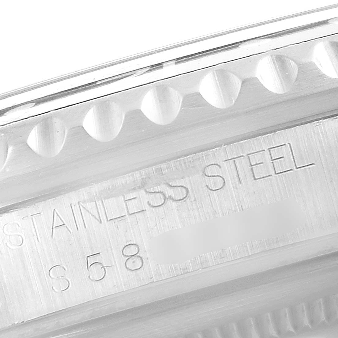 This image shows a close-up of the side of a Rolex GMT-Master 16700 Men's Stainless Steel Black Dial 16700 Men's Stainless Steel Black Dial watch, highlighting its stainless steel engraving.