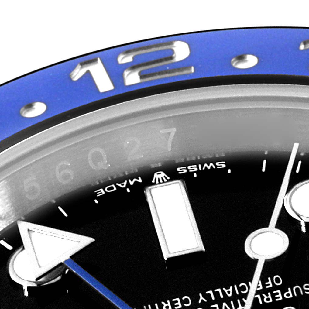 This close-up image of the Rolex GMT-Master 126710BLNR Men
s Stainless Steel Black Dial 126710BLNR Men
s Stainless Steel Black Dial watch shows a portion of the blue bezel, hour markers, and part of the GMT hand.