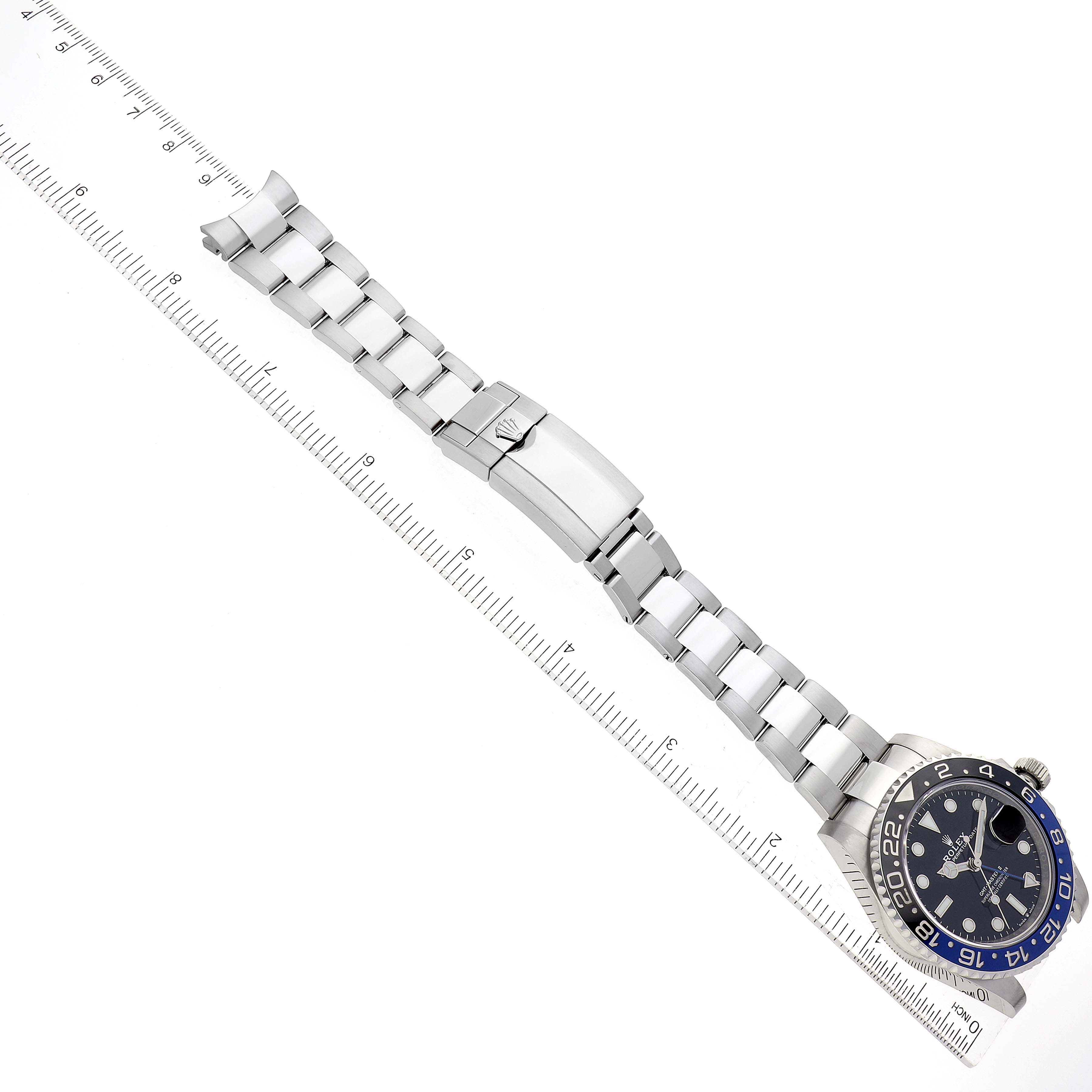 The image shows a top-down view of a Rolex GMT-Master 126710 Men's Stainless Steel Black Dial 126710 Men's Stainless Steel Black Dial watch with its stainless steel bracelet fully extended.