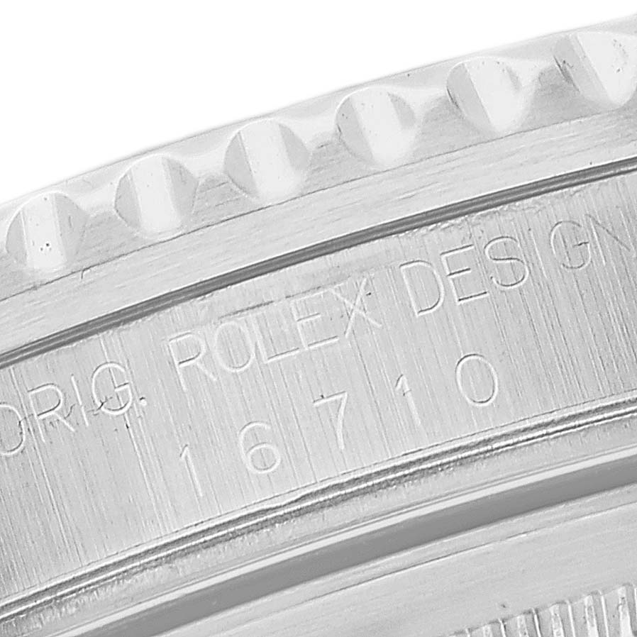 This image shows a close-up of the bezel and engraved serial number of a Rolex GMT-Master 16710 Men
s Stainless Steel Black Dial 16710 Men
s Stainless Steel Black Dial model 16710.