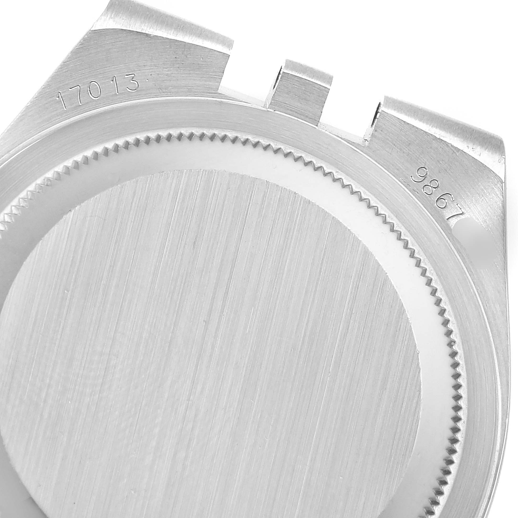 The image shows the back part of a Rolex Oysterquartz 17013 Men's Steel and Gold (two tone) Champagne Dial 17013 Men's Steel and Gold (two tone) Champagne Dial watch case and serial numbers, viewed from a top-down angle.