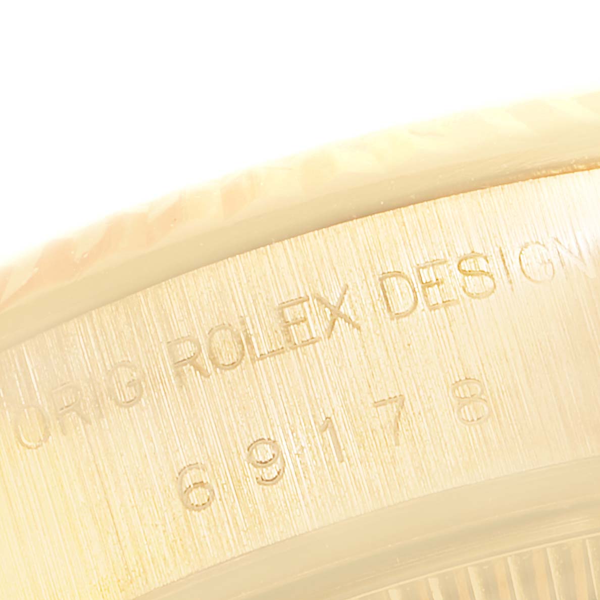 This image shows a close-up of the side engraving on the bezel of the Rolex President 69178 Women's Yellow Gold Champagne Dial 69178 Women's Yellow Gold Champagne Dial model watch.