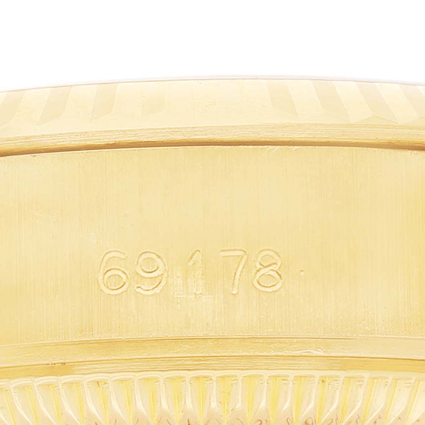 The image shows a close-up of the side of a Rolex President 69178 Women's Yellow Gold Grey Dial watch, highlighting the engraved model number "69178" and part of the case.