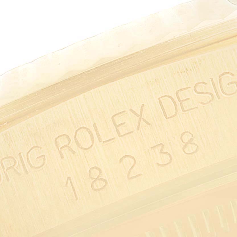 The image shows a close-up of the engraving on the case back of a Rolex President 18238 Men
s Yellow Gold Champagne Dial 18238 Men
s Yellow Gold Champagne Dial model watch.