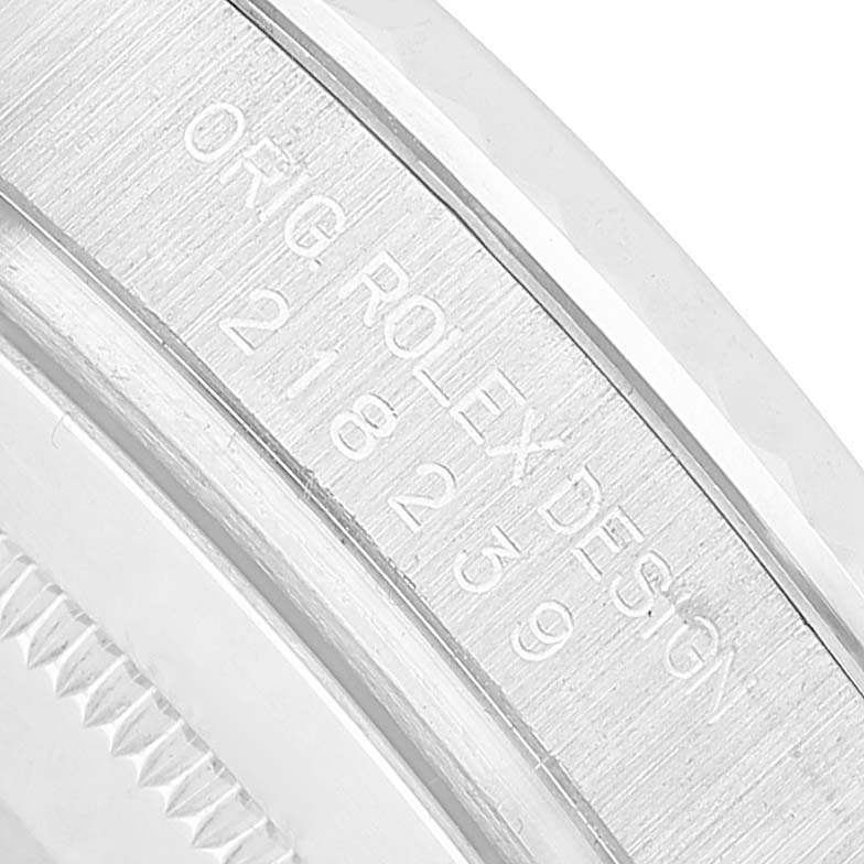 The image shows a close-up of the engraving on the inner bezel of a Rolex President 218239 Men's White Gold Black Dial model.