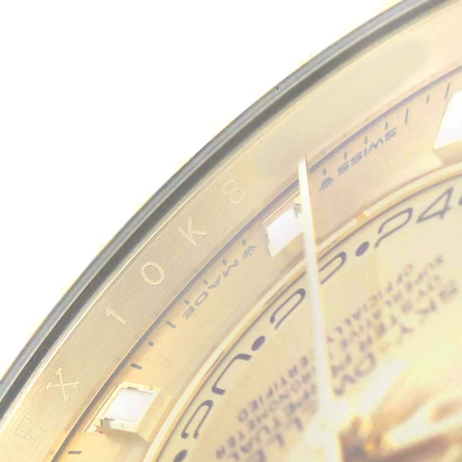 The image shows a close-up of the Rolex Sky-Dweller 336238 Men's Yellow Gold Champagne Dial watch, focusing on part of the dial and bezel.