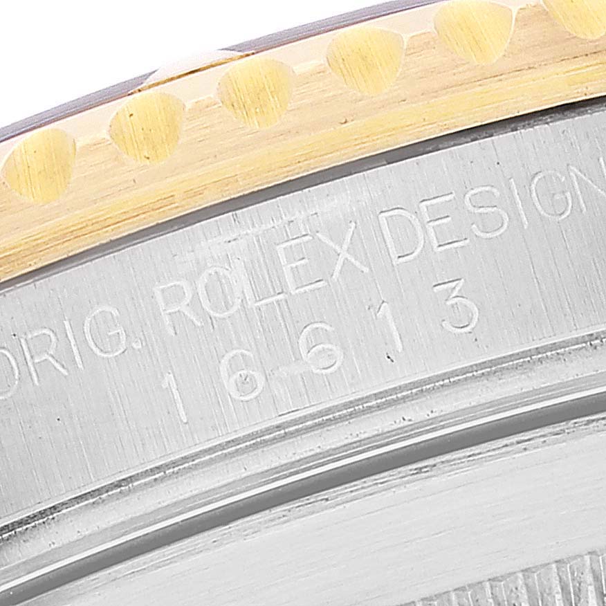 The image shows a close-up of the bezel and engraved case side of a Rolex Submariner 16613 Men's Steel and Gold (two tone) Blue Dial 16613 Men's Steel and Gold (two tone) Blue Dial model.
