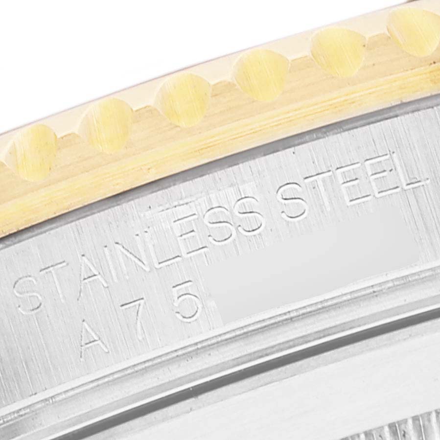 The image shows a close-up angle of the bezel edge and the case back inscription of a Rolex Submariner 16613 Men's Steel and Gold (two tone) Blue Dial 16613 Men's Steel and Gold (two tone) Blue Dial watch.