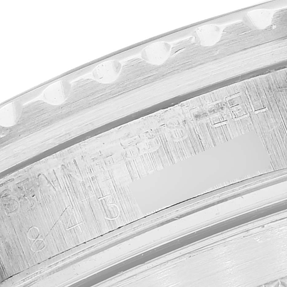 The image shows a close-up view of the edge and engravings on a Vintage Collection Rolex watch's bezel.
