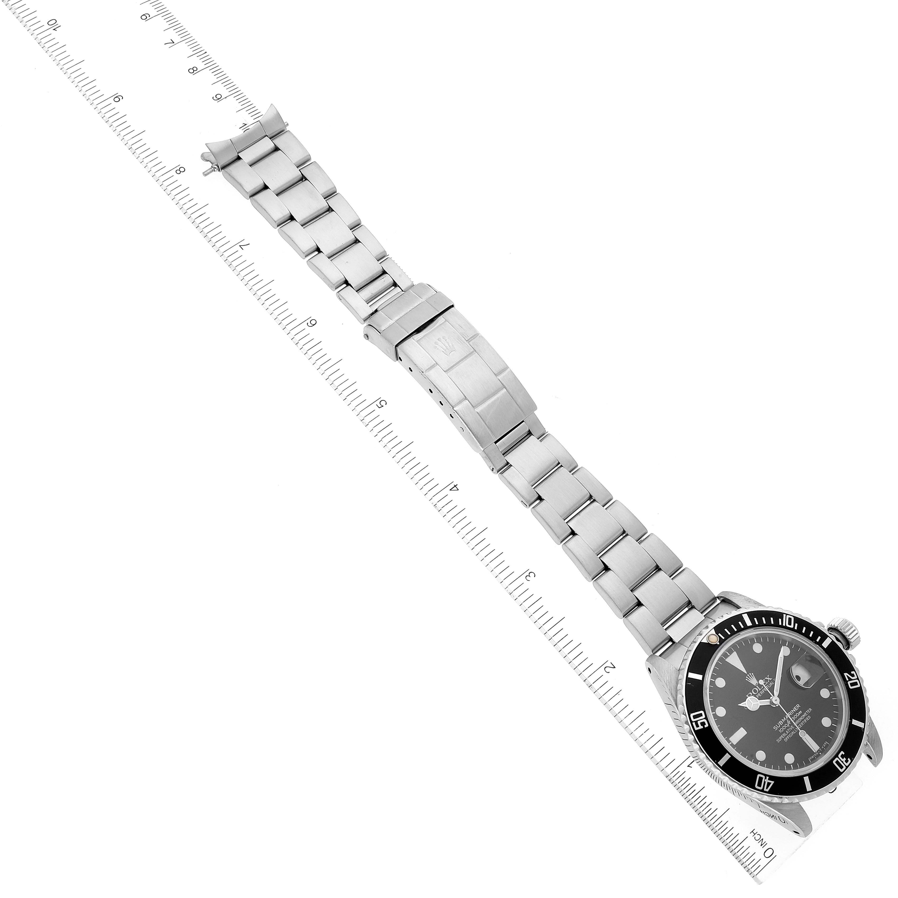 The image shows an overhead view of a Rolex Vintage Collection 16800 Men's Stainless Steel Black Dial 16800 Men's Stainless Steel Black Dial watch, highlighting its bracelet, clasp, and watch face alongside a ruler.