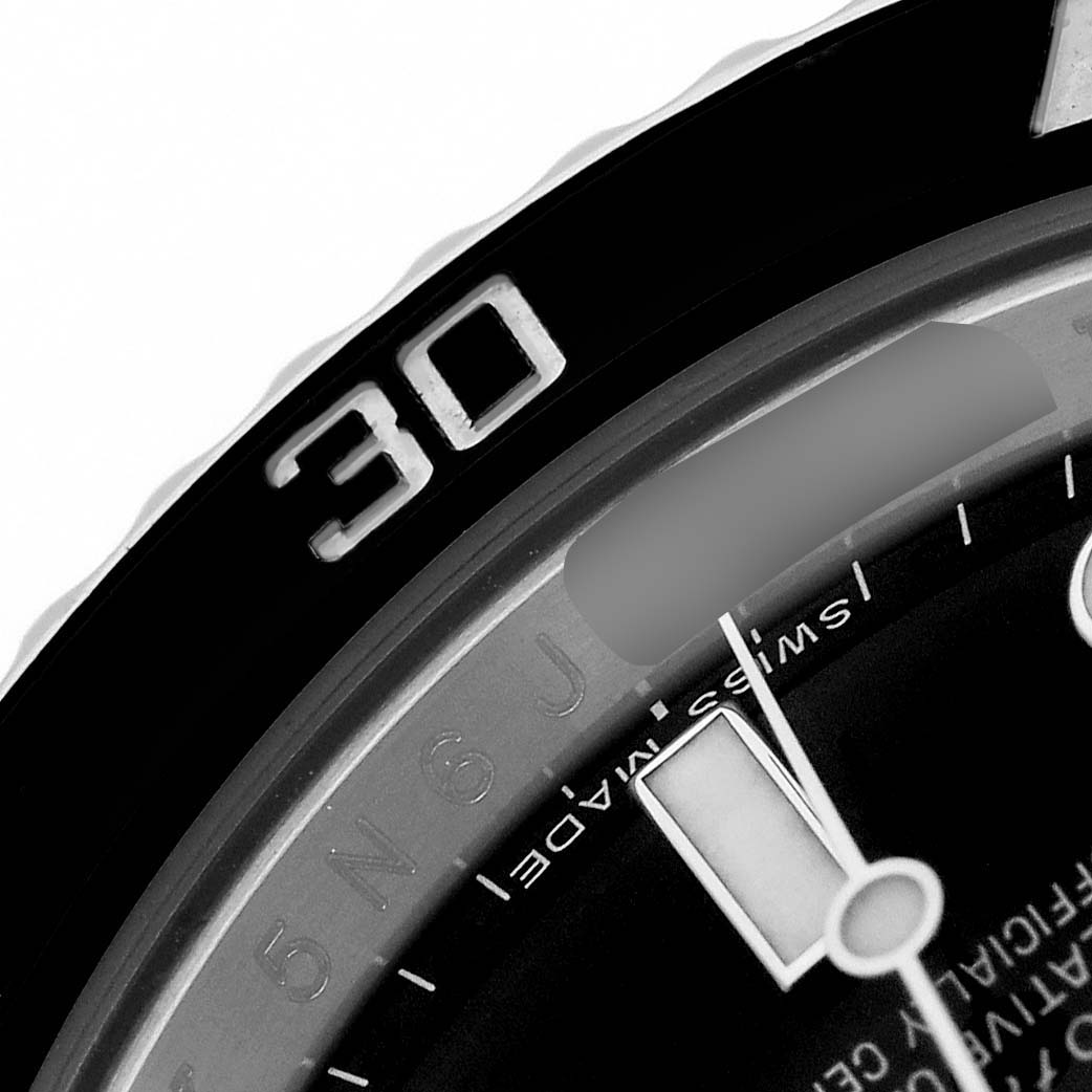 The close-up angle of the Rolex Submariner 114060 Men's Stainless Steel Black Dial shows its bezel and part of the dial with the hour marker and "Swiss Made" text.