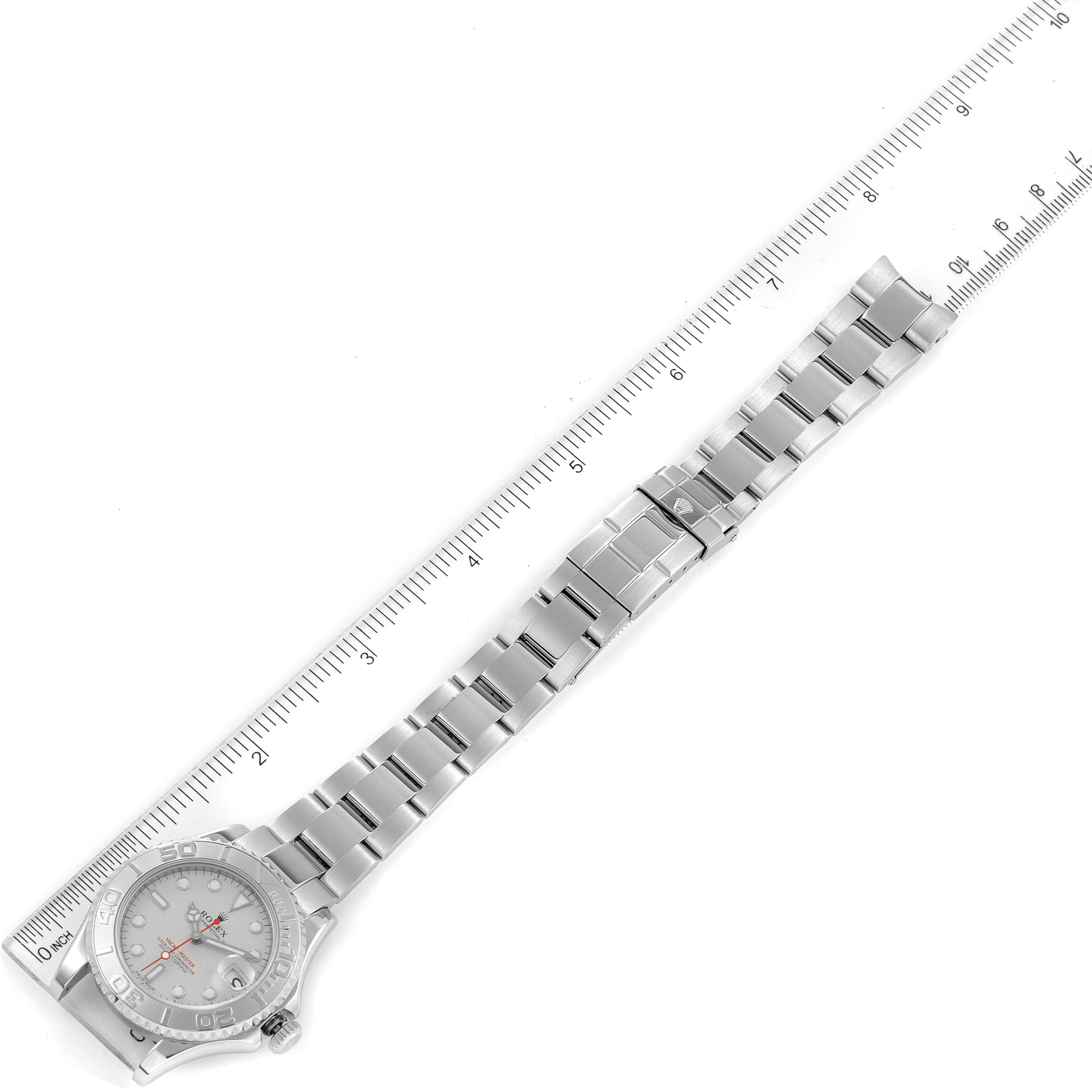 The Yacht-Master watch by Rolex is shown fully extended and flat with a ruler for scale.