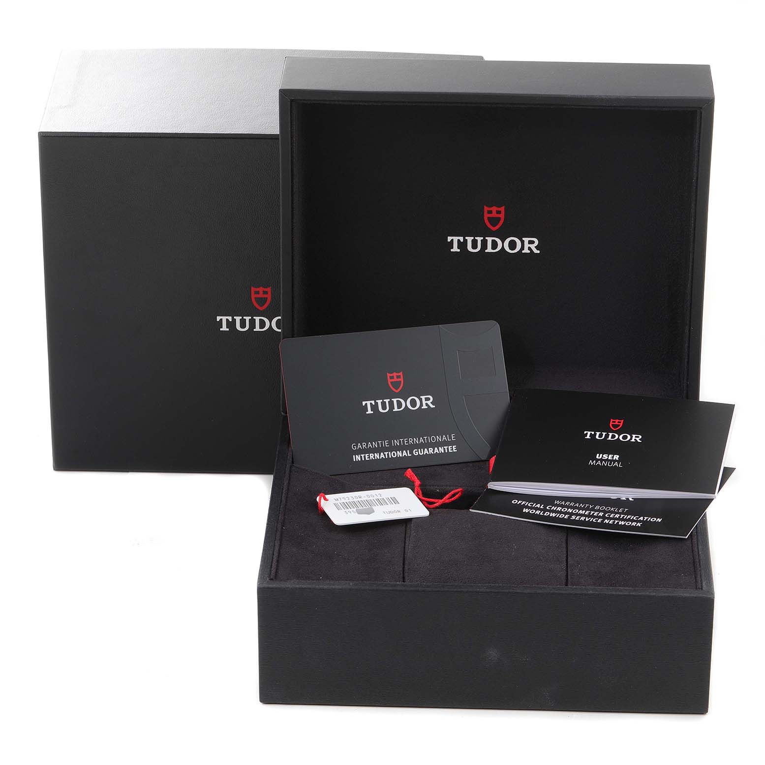 This image shows the packaging, international guarantee card, tags, and user manual for the Tudor Heritage Black Bay M79230R-0012 Men's Stainless Steel Black Dial M79230R-0012 Men's Stainless Steel Black Dial watch.