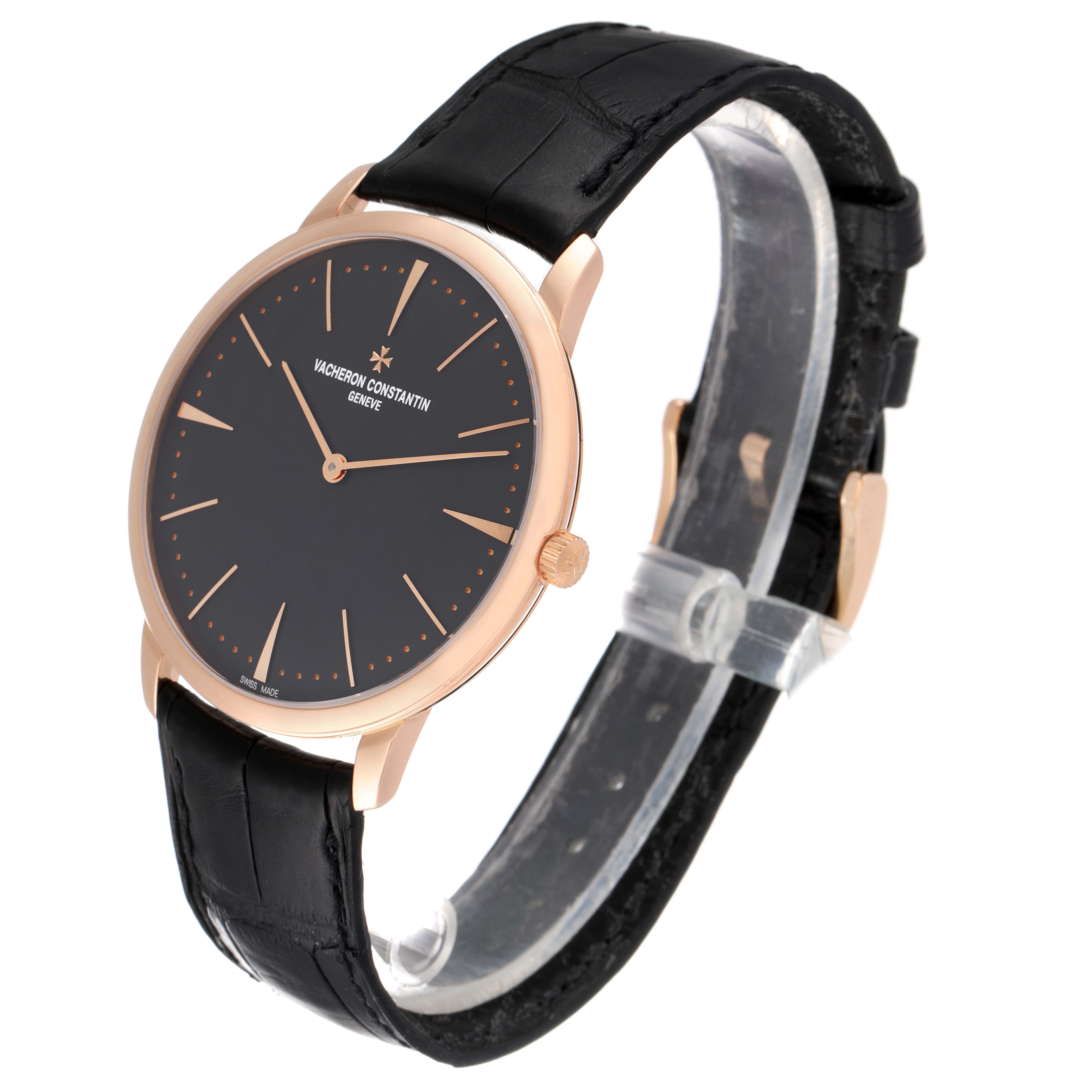 The image shows a Vacheron Constantin Patrimony 81180R/000R-9162 Men's Rose Gold Grey Dial 81180R/000R-9162 Men's Rose Gold Grey Dial watch from a three-quarter angle, displaying its black dial, rose gold case, and black leather strap.