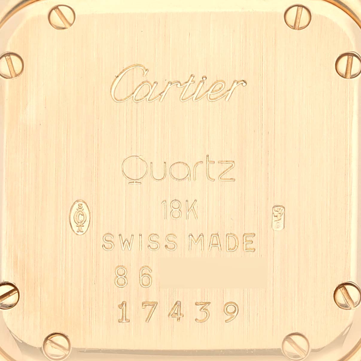 This image shows the back case of a Cartier Panthere 17439 Women's Yellow Gold Silver Dial 17439 Women's Yellow Gold Silver Dial model watch, displaying its engravings and screws.