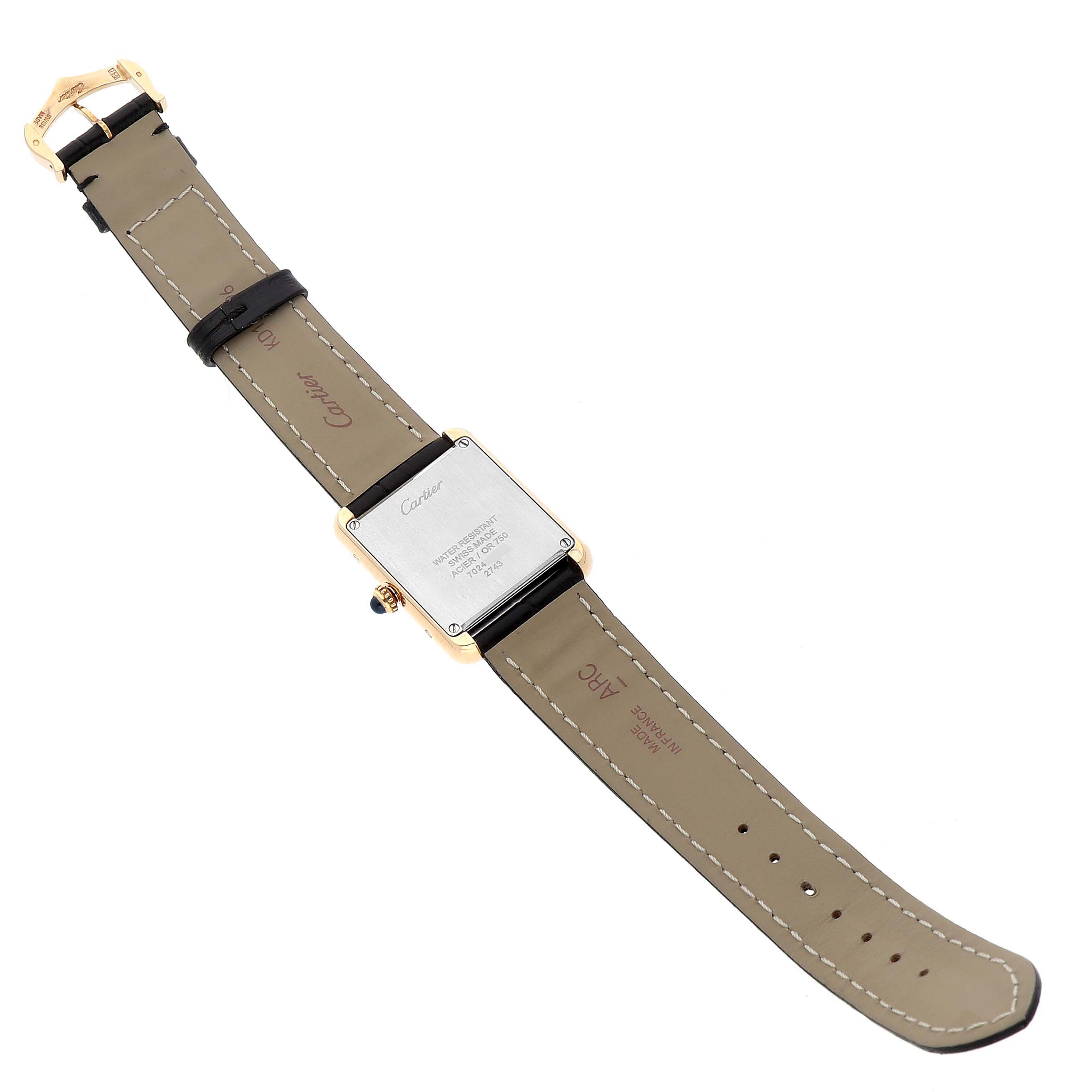 The Cartier Tank Solo W1018755 Women's Steel and Gold (two tone) Silver Dial watch is shown from the back, highlighting the case back, strap, and buckle.