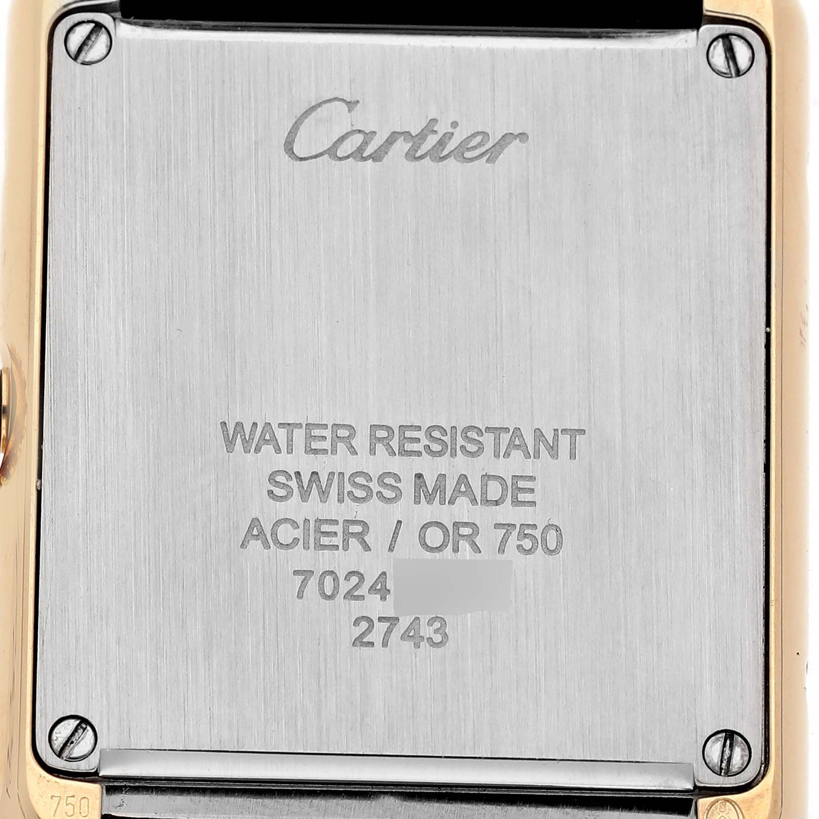 The image shows the back casing of a Cartier Tank Solo W1018755 Women's Steel and Gold (two tone) Silver Dial watch, highlighting branding and specifications.