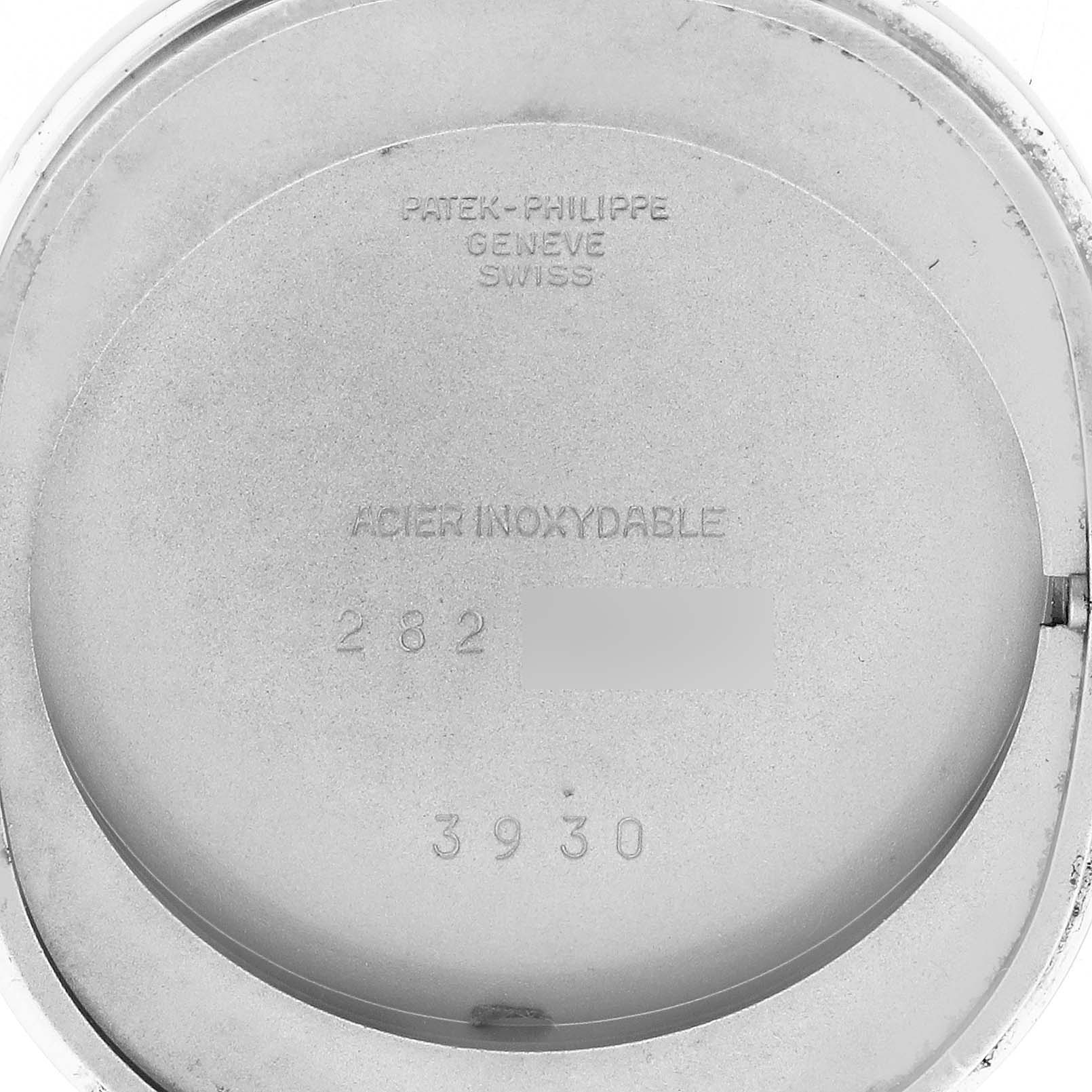 This image shows the back cover of a Patek Philippe Golden Ellipse 3930 Men's Stainless Steel Blue Dial 3930 Men's Stainless Steel Blue Dial watch, highlighting the interior markings and engravings.