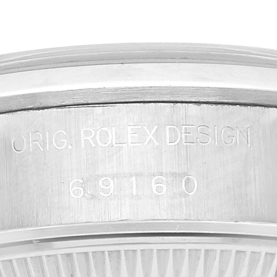 This close-up image shows the side engraving of the Rolex Datejust 69160 Women's Stainless Steel Blue Dial 69160 Women's Stainless Steel Blue Dial watch, featuring the model number and "ORIG. ROLEX DESIGN" text.