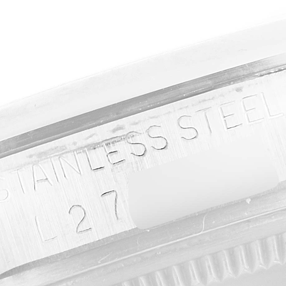 This image shows a close-up of the side of a stainless steel Rolex Vintage Collection 15000 Men
s Stainless Steel Champagne Dial 15000 Men
s Stainless Steel Champagne Dial model watch case with engraved details.