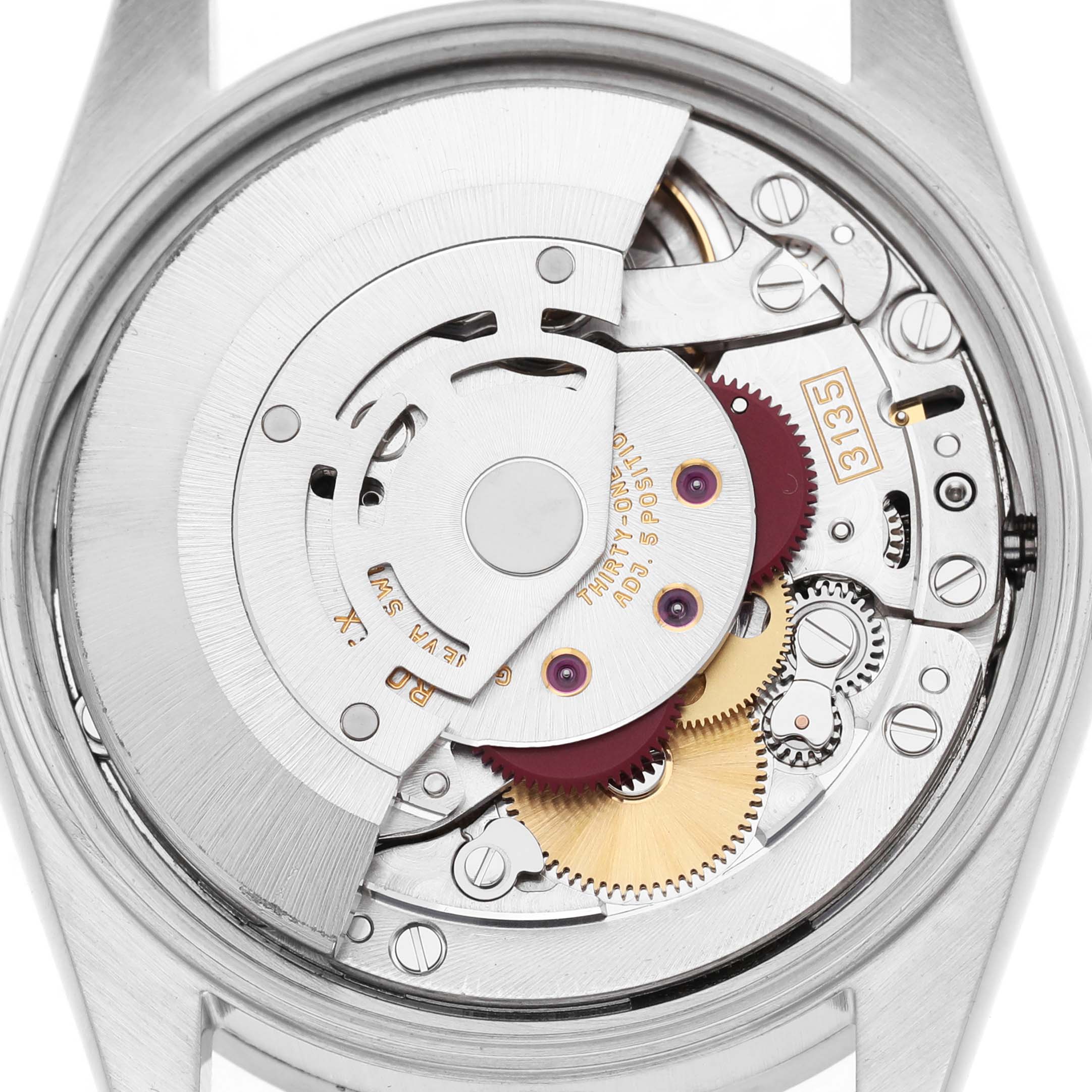 The image shows the open case back of a Rolex Date 15210 Men's Stainless Steel Silver Dial model, revealing its detailed movement and gears.