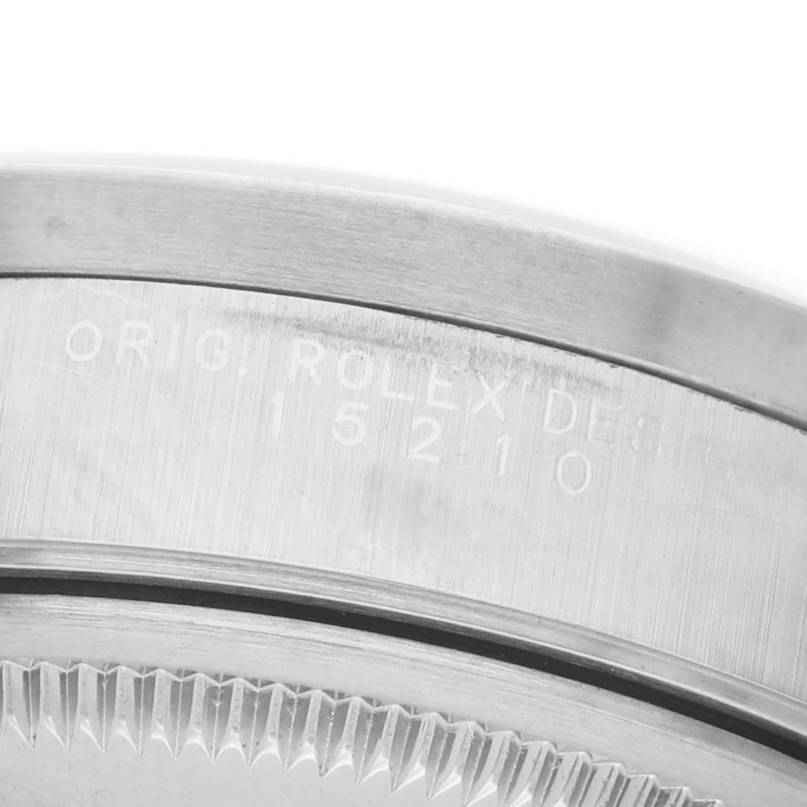 The image shows a close-up of the side engraving and bezel teeth on a Rolex Date 15210 Men's Stainless Steel Silver Dial model watch.