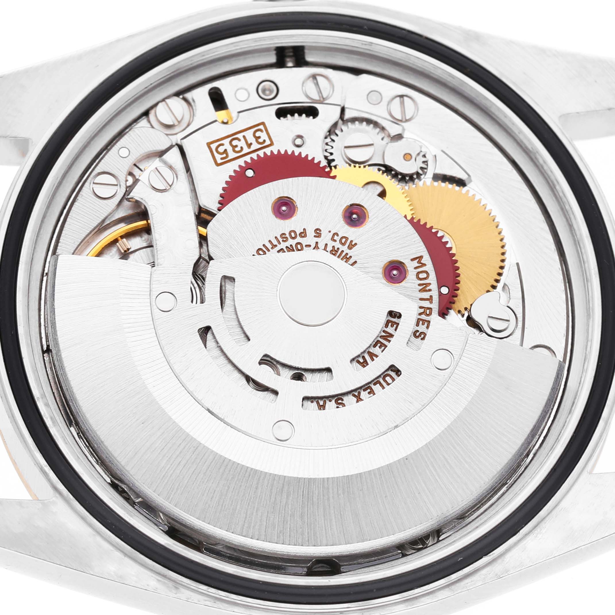 The image shows a close-up of the movement mechanism of a Rolex Datejust 16233 Men's Steel and Gold (two tone) Champagne Dial, highlighting gears and internal components.