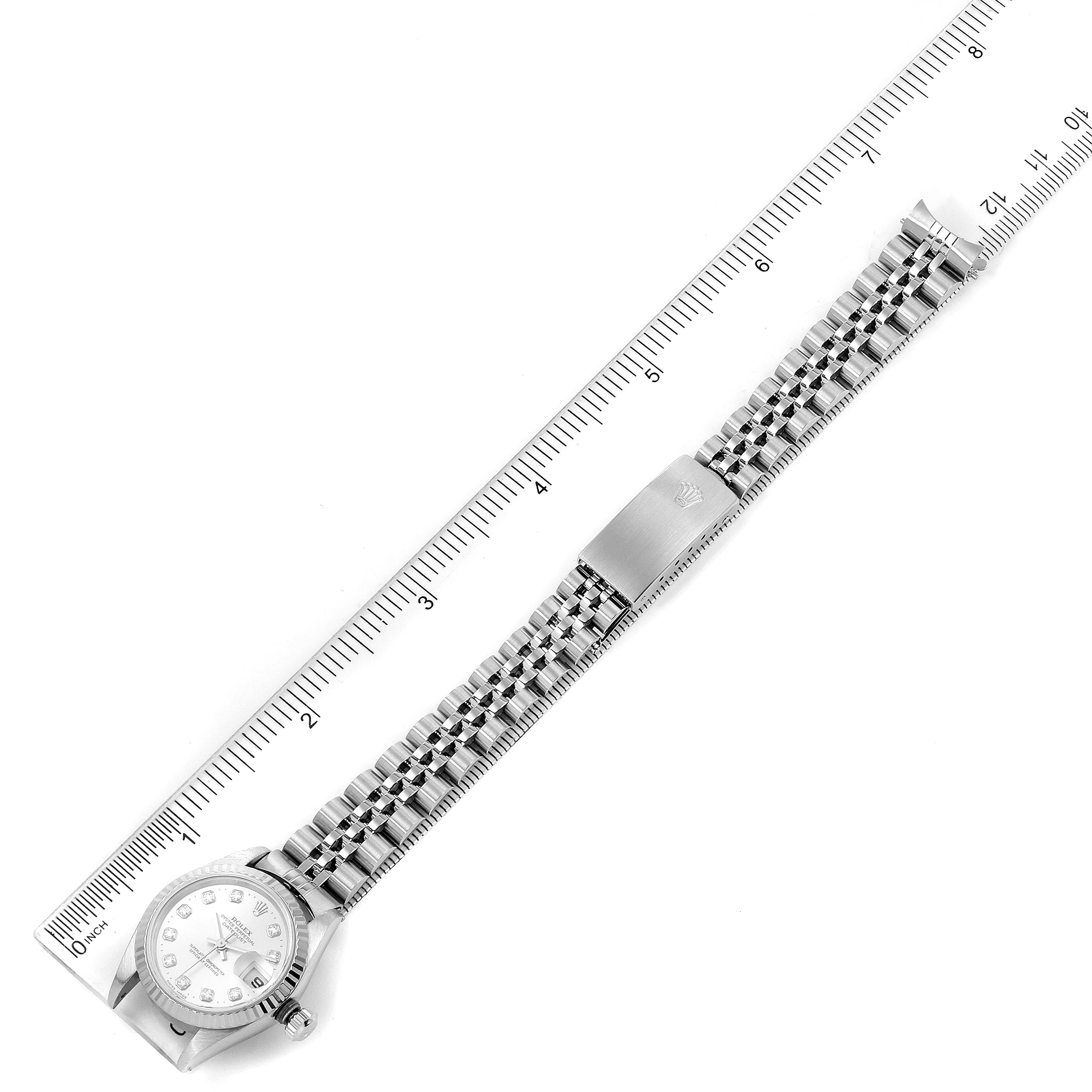 The image shows a top-down view of the entire Rolex Datejust 79174 Women's Stainless Steel Silver Dial 79174 Women's Stainless Steel Silver Dial watch, including its face and bracelet, against a ruler backdrop.