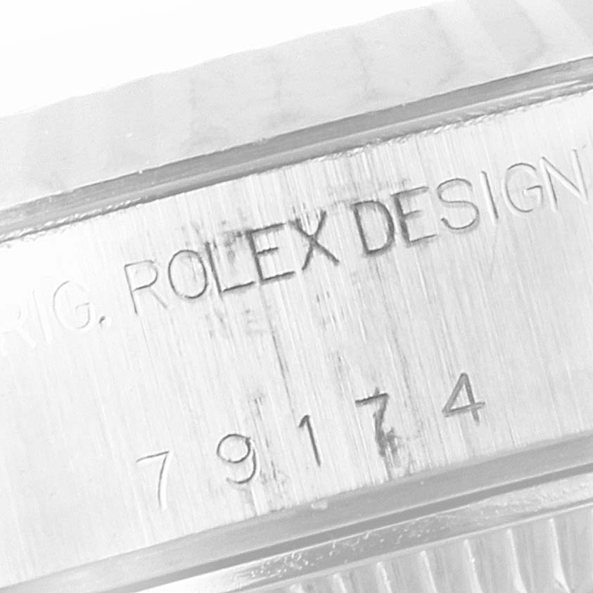 The image shows a close-up of the engraved serial and model number on the side of a Rolex Datejust 79174 Women's Stainless Steel Silver Dial 79174 Women's Stainless Steel Silver Dial watch case.