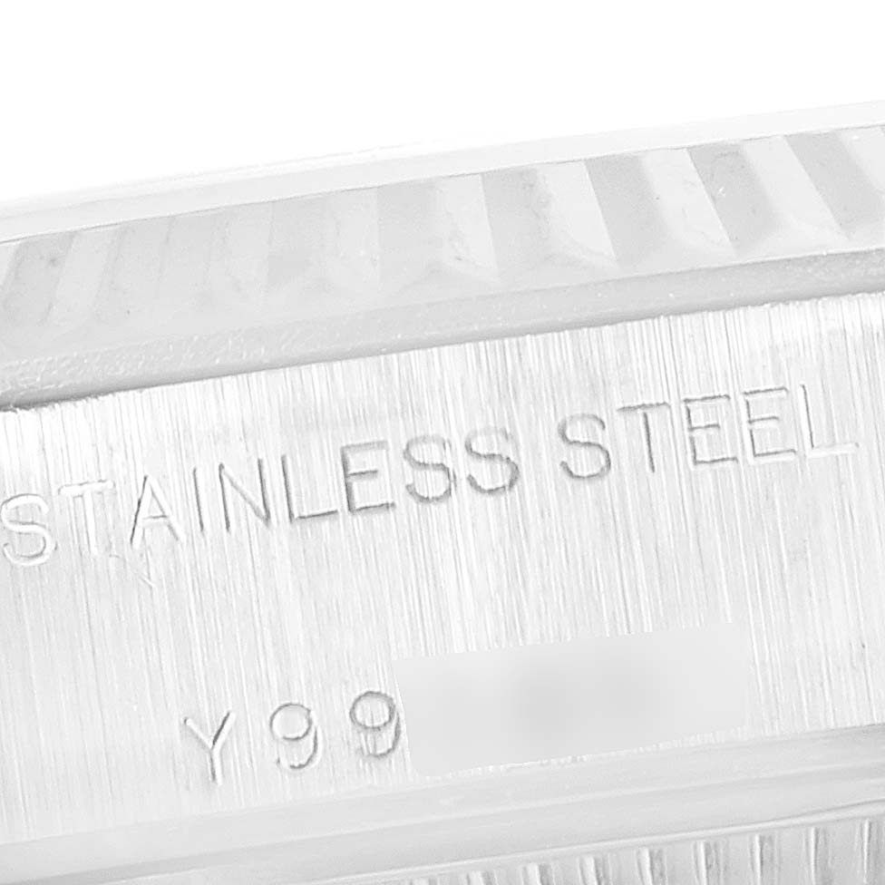 This close-up image shows part of the stainless steel case and engraving on a Rolex Datejust 79174 Women's Stainless Steel Silver Dial 79174 Women's Stainless Steel Silver Dial watch.