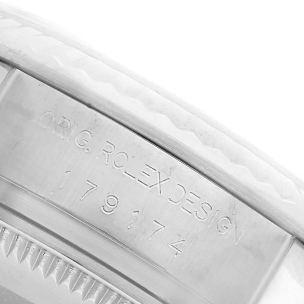 The image shows a close-up of the engraved bezel edge and side of a Rolex Datejust 179174 Women
s Stainless Steel Silver Dial 179174 Women
s Stainless Steel Silver Dial watch.