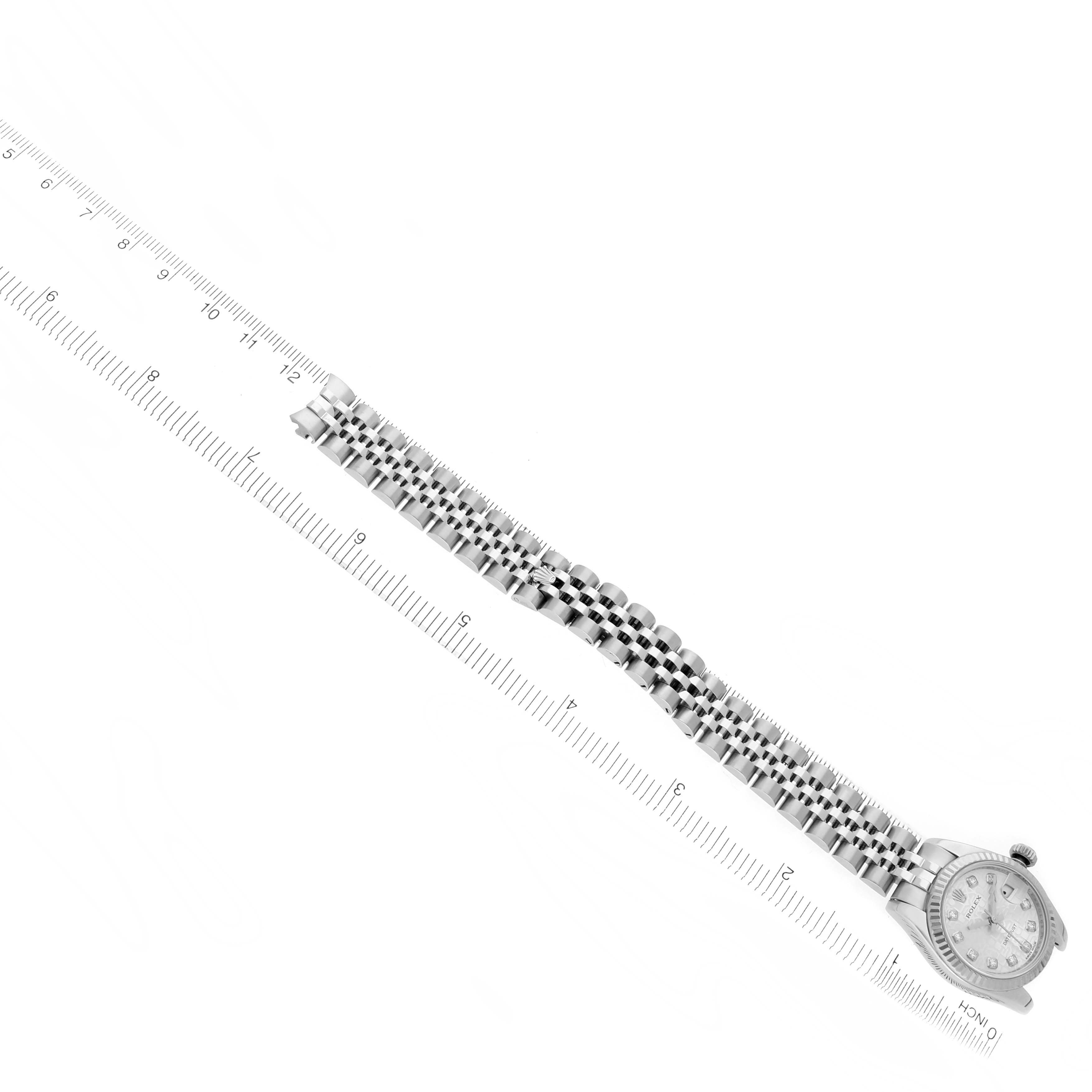 The image shows a Rolex Datejust 179174 Women
s Stainless Steel Silver Dial 179174 Women
s Stainless Steel Silver Dial watch laid flat, highlighting its bracelet alongside a measuring scale.