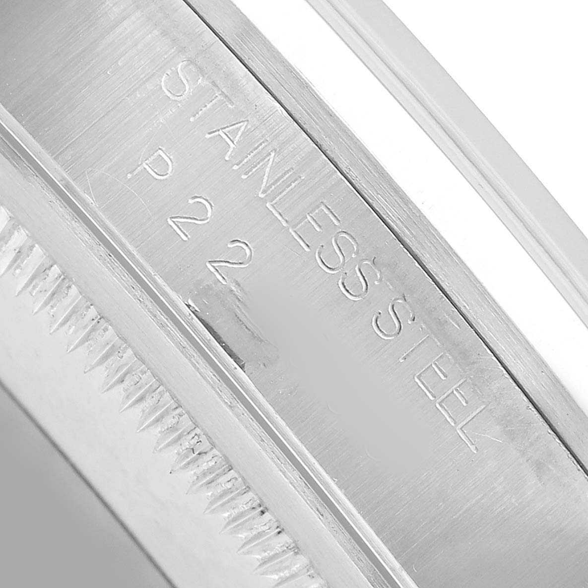 The image shows a close-up of the side edge, engravings, and part of the bezel of a Rolex Datejust 16200 Men's Stainless Steel White Dial watch.