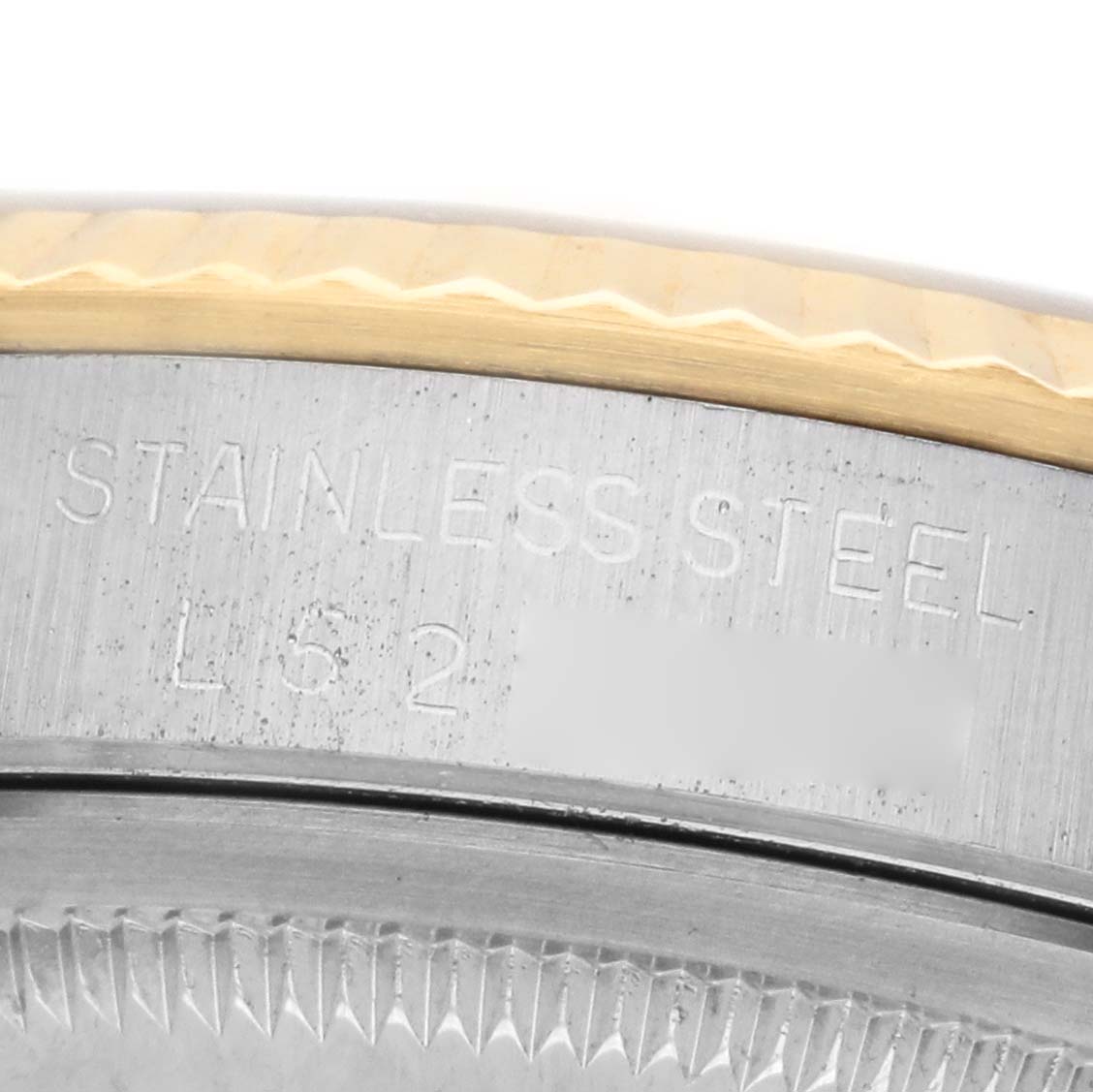 The image shows a close-up of the side of a Rolex Datejust 16233 Men's Steel and Gold (two tone) Champagne Dial, highlighting its stainless steel case and part of the fluted bezel.