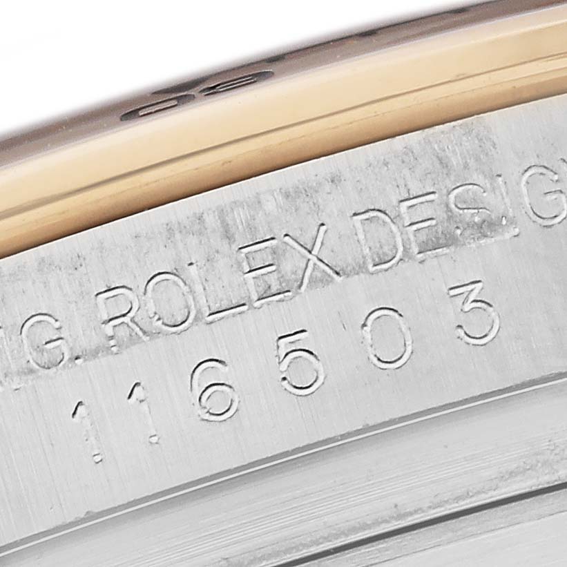 The image shows a close-up of the case side of a Rolex Daytona 116503-0004 Men's Steel and Gold (two tone) Black Dial 116503-0004 Men's Steel and Gold (two tone) Black Dial, highlighting the engraved model number and details.