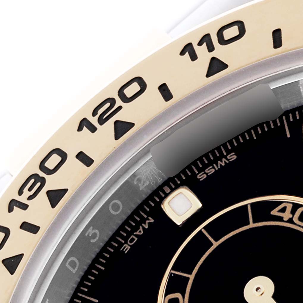 The image shows a close-up of the bezel and part of the dial of a Rolex Daytona 116503-0004 Men's Steel and Gold (two tone) Black Dial 116503-0004 Men's Steel and Gold (two tone) Black Dial watch, highlighting the tachymetric scale.