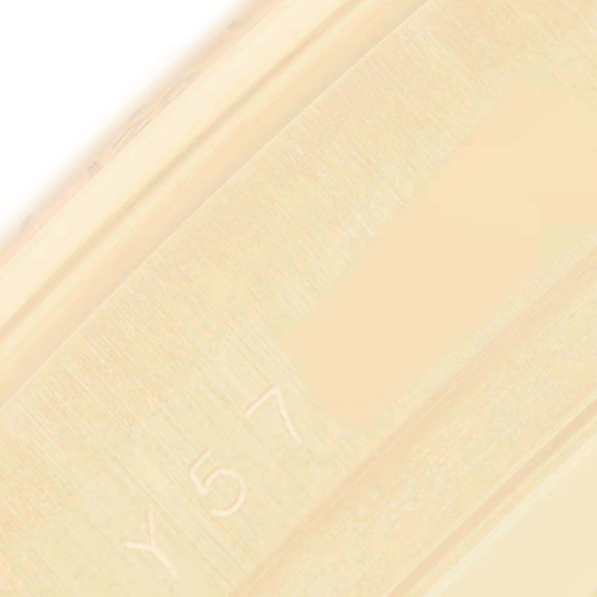 The image shows a close-up of the inner engraving on the case of a Rolex Daytona 116528 Men's Yellow Gold White Dial 116528 Men's Yellow Gold White Dial watch.