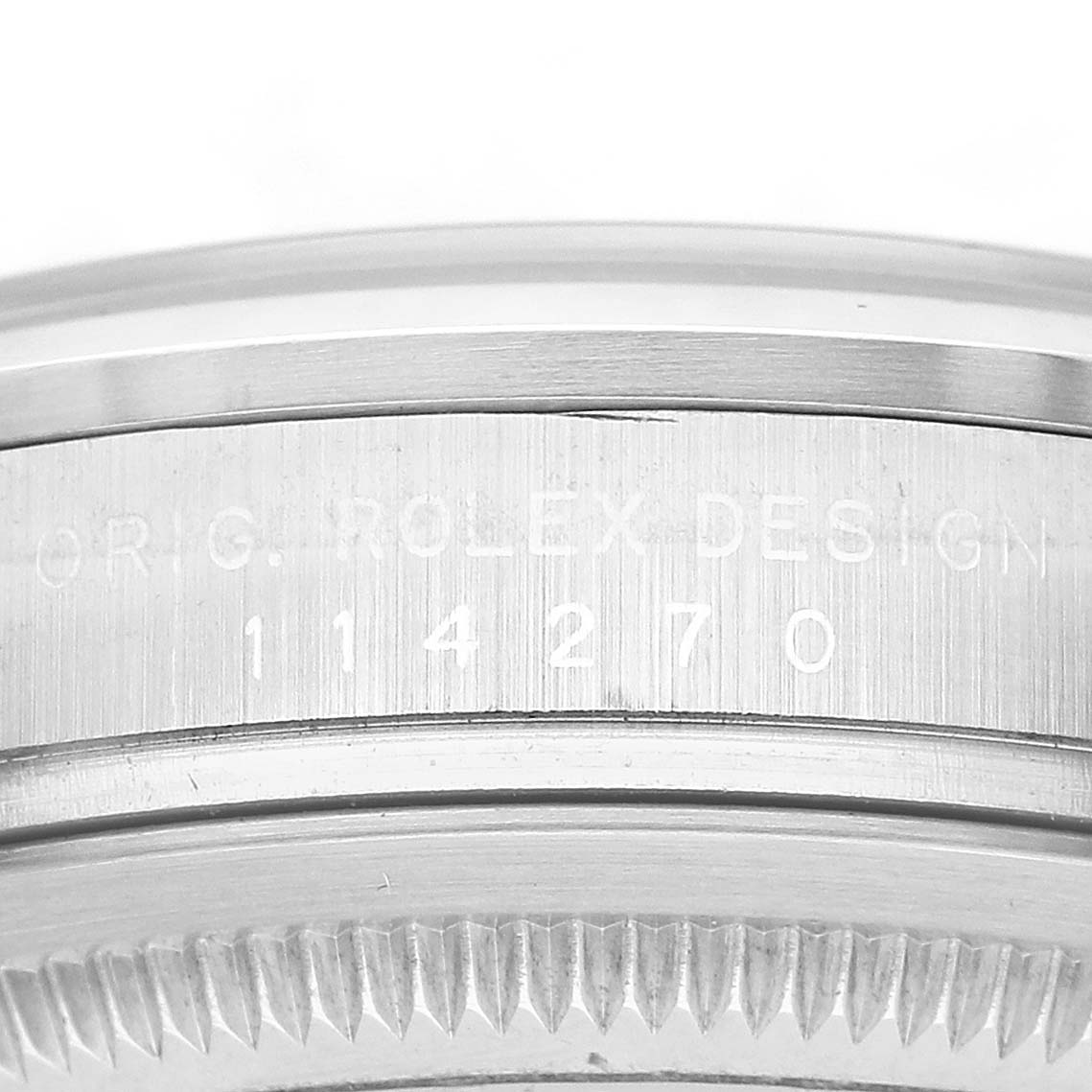The image shows a close-up side view of the bezel edge and engraved model number of a Rolex Explorer 114270 Men's Stainless Steel Black Dial.