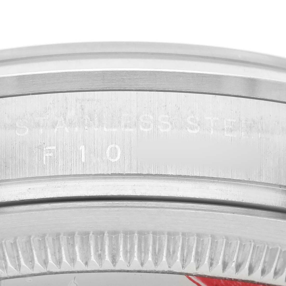 The image shows a close-up of the side and edge of a Rolex Explorer 114270 Men's Stainless Steel Black Dial watch case, highlighting the "STAINLESS STEEL" engraving.
