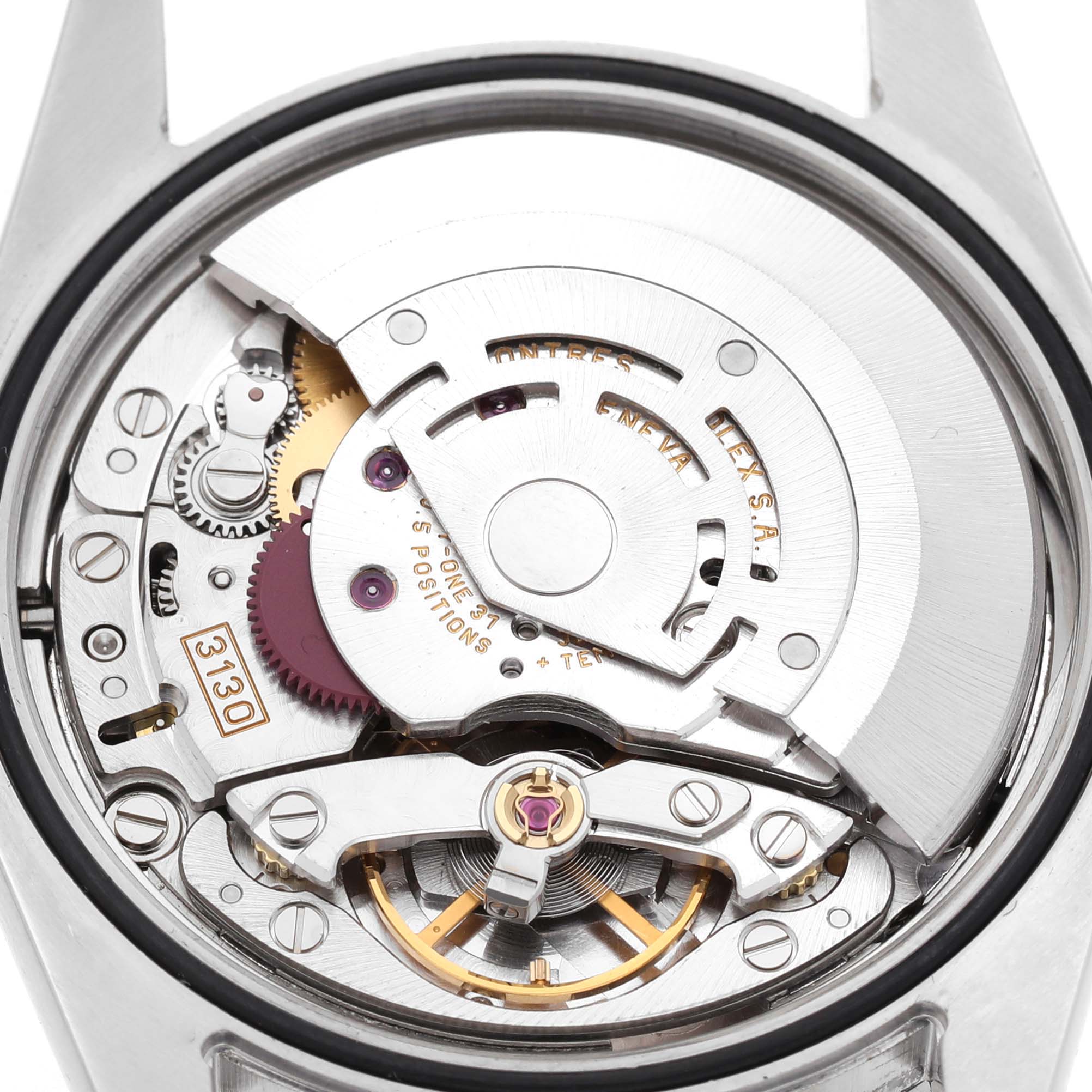 The image shows the movement of a Rolex Explorer 114270 Men's Stainless Steel Black Dial watch, featuring gears and the rotor from a back angle.