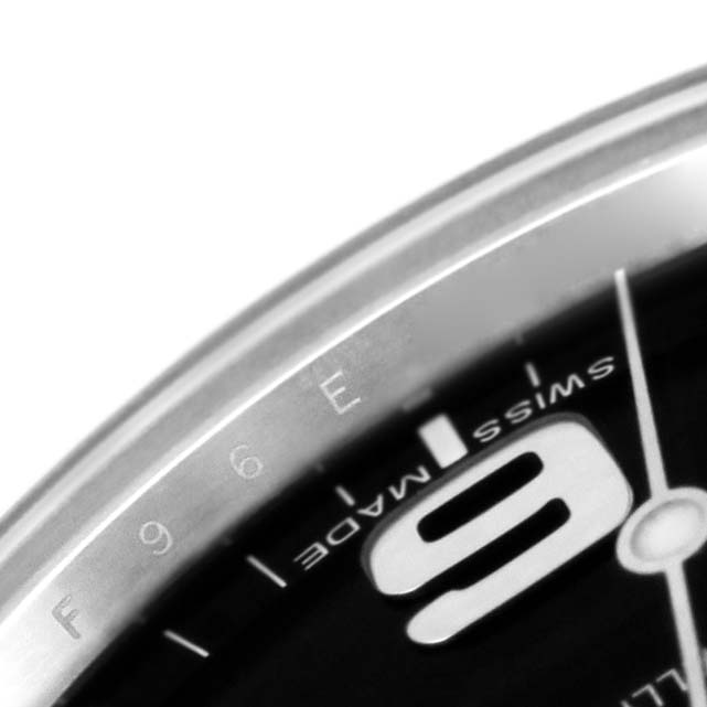 This image shows a close-up of the Rolex Explorer 214270 Men's Stainless Steel Black Dial 214270 Men's Stainless Steel Black Dial watch dial, focusing on the "9" marker and adjacent markings.