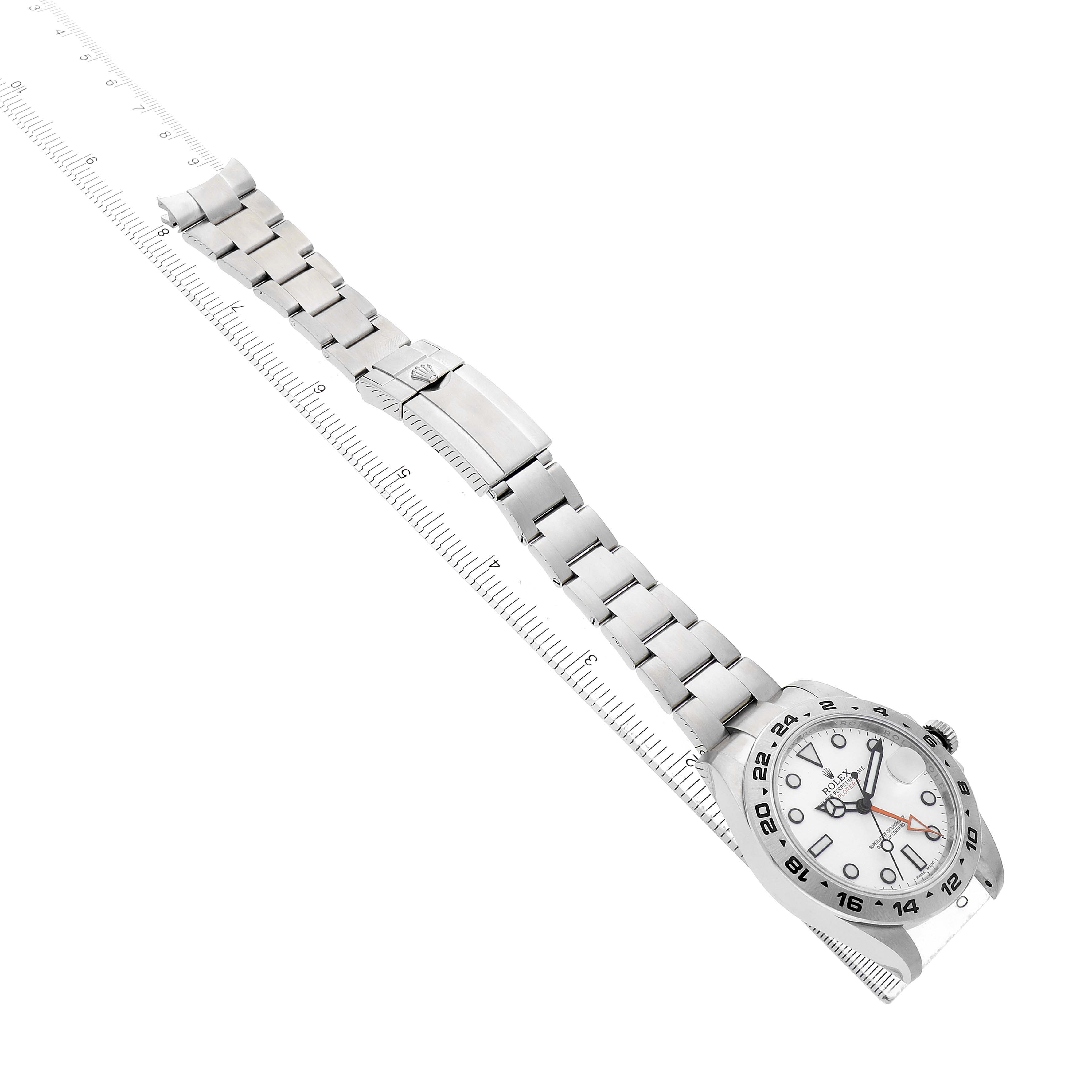 The image shows a Rolex Explorer 216570 Men's Stainless Steel White Dial watch and bracelet at a diagonal angle with the face and clasp visible.