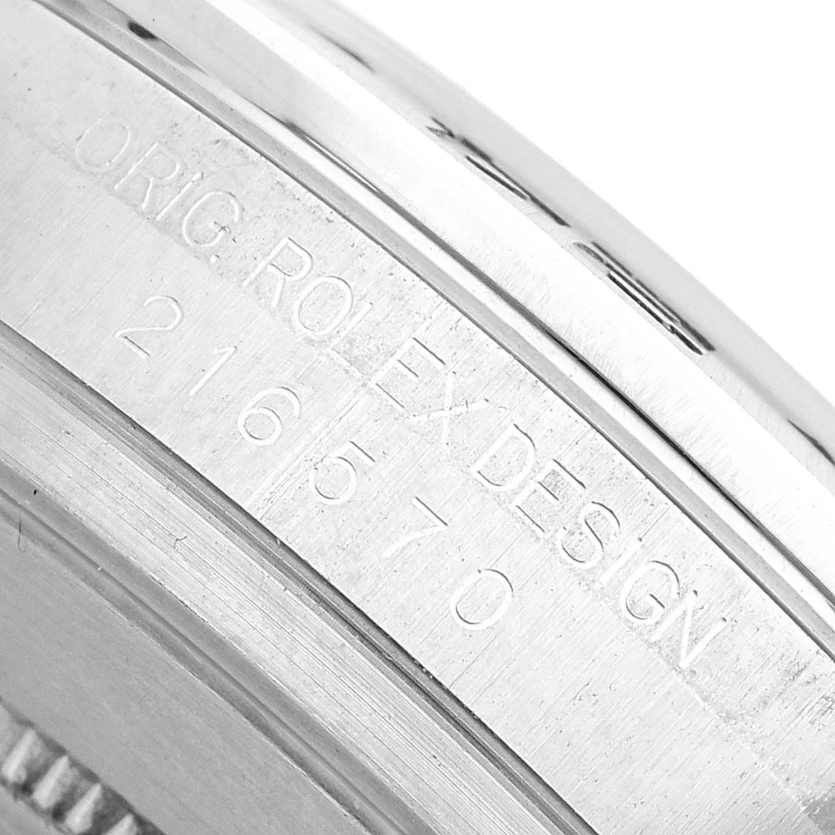 The image shows an angled close-up of the case side with engravings on the Rolex Explorer 216570 Men's Stainless Steel White Dial watch.
