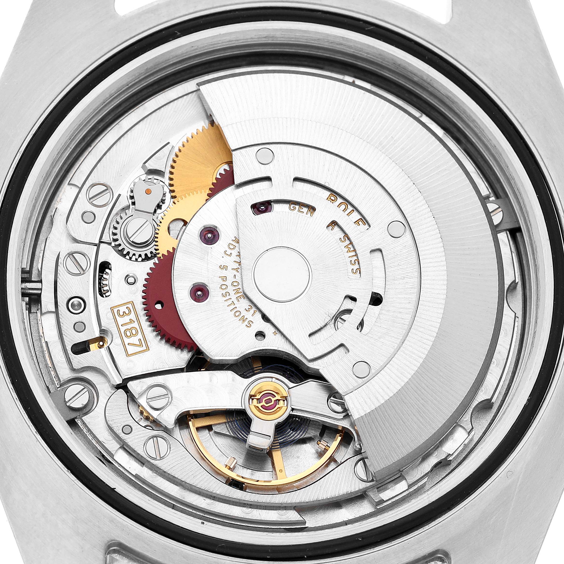 The image shows the movement of a Rolex Explorer 216570 Men's Stainless Steel White Dial watch from a rear, internal angle, highlighting gears and the balance wheel.