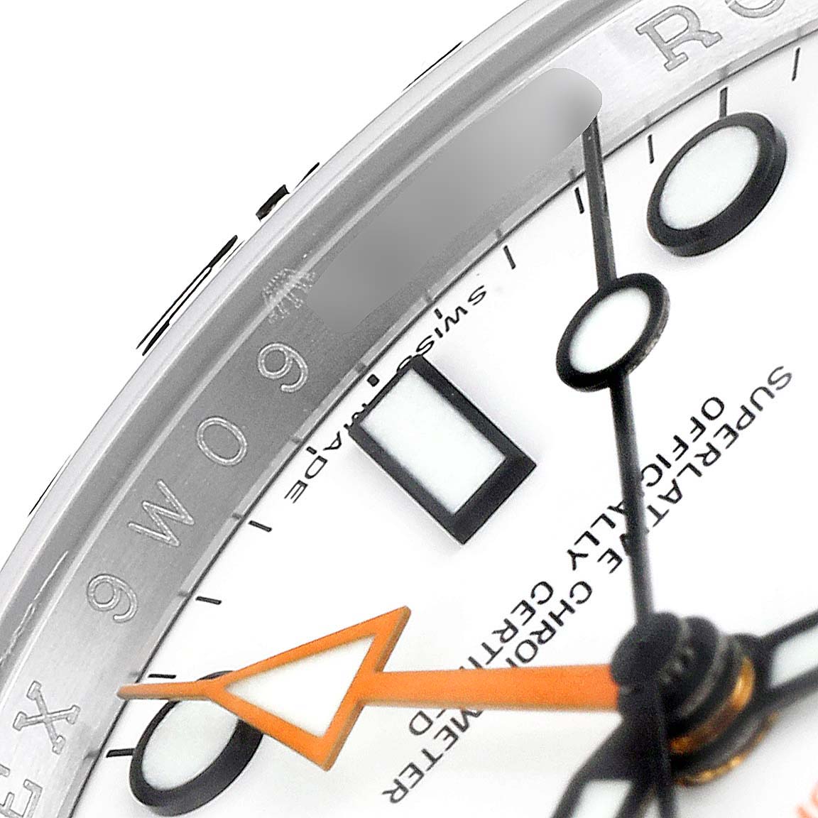 This close-up image of the Rolex Explorer 216570 Men's Stainless Steel White Dial 216570 Men's Stainless Steel White Dial model shows the watch face, markers, part of the second and minute hands, and the bezel markings.