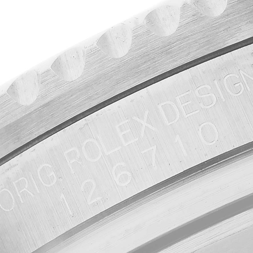 The image shows a close-up of the engraved side of the case on a Rolex GMT-Master 126710 Men's Stainless Steel Black Dial watch.