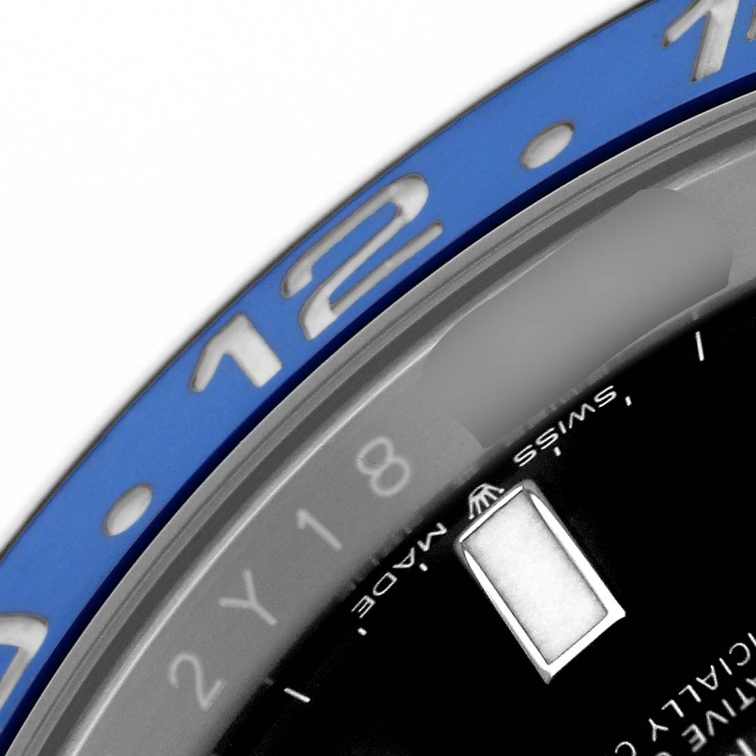 The image shows a close-up of the Rolex GMT-Master 126710 Men's Stainless Steel Black Dial bezel, hour markers, and partial dial from an angled top view.