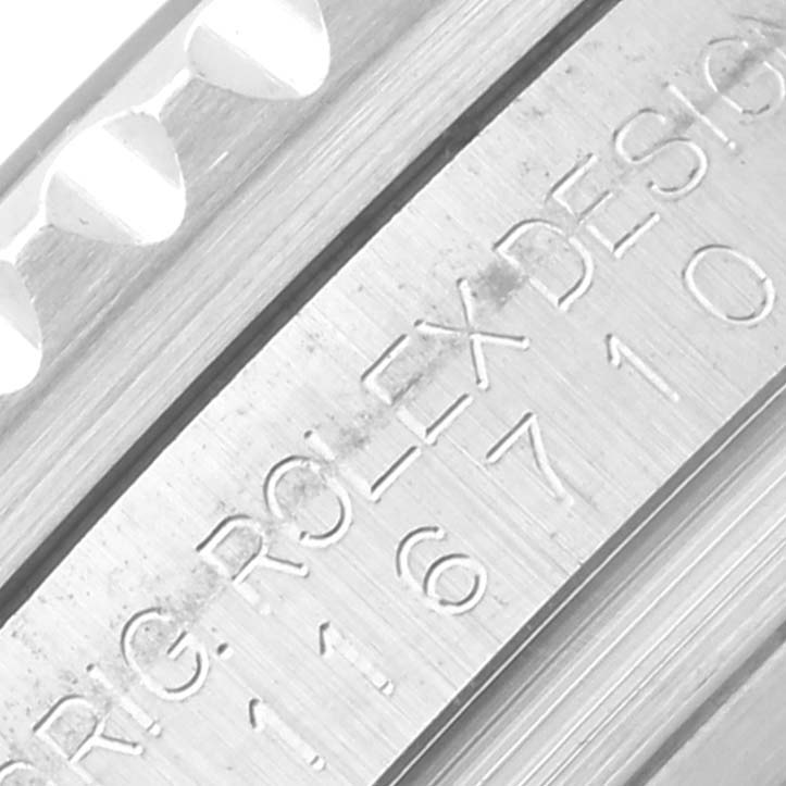 The image shows a close-up of the edge and engraved branding/serial details on the Rolex GMT-Master 116710LN Men's Stainless Steel Black Dial 116710LN Men's Stainless Steel Black Dial bezel.